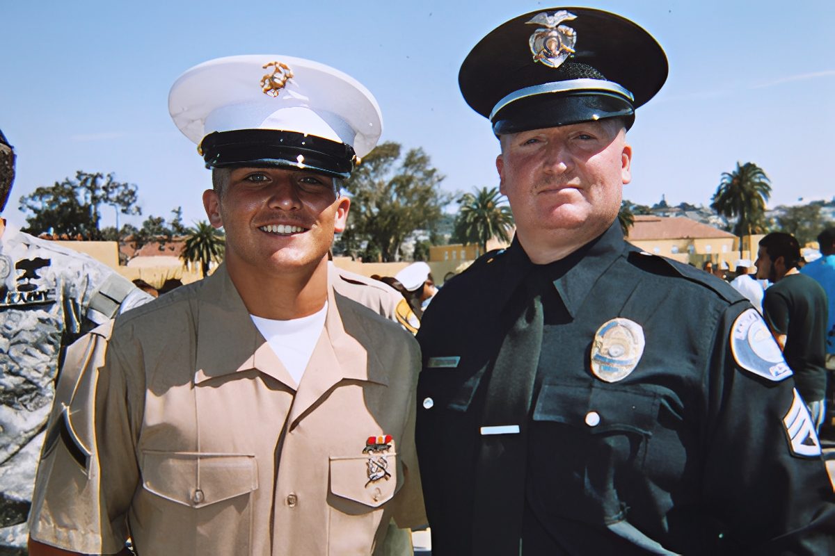 Smiling Marine and police officer posing outdoors