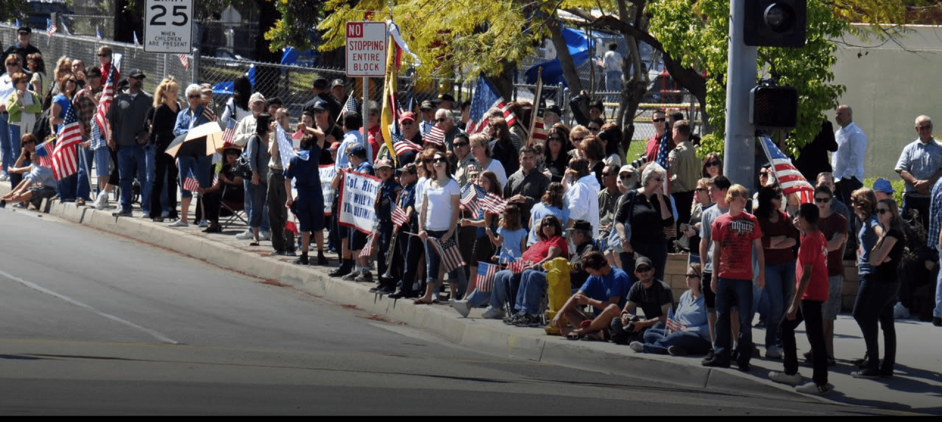 Parade crowd waving American flags