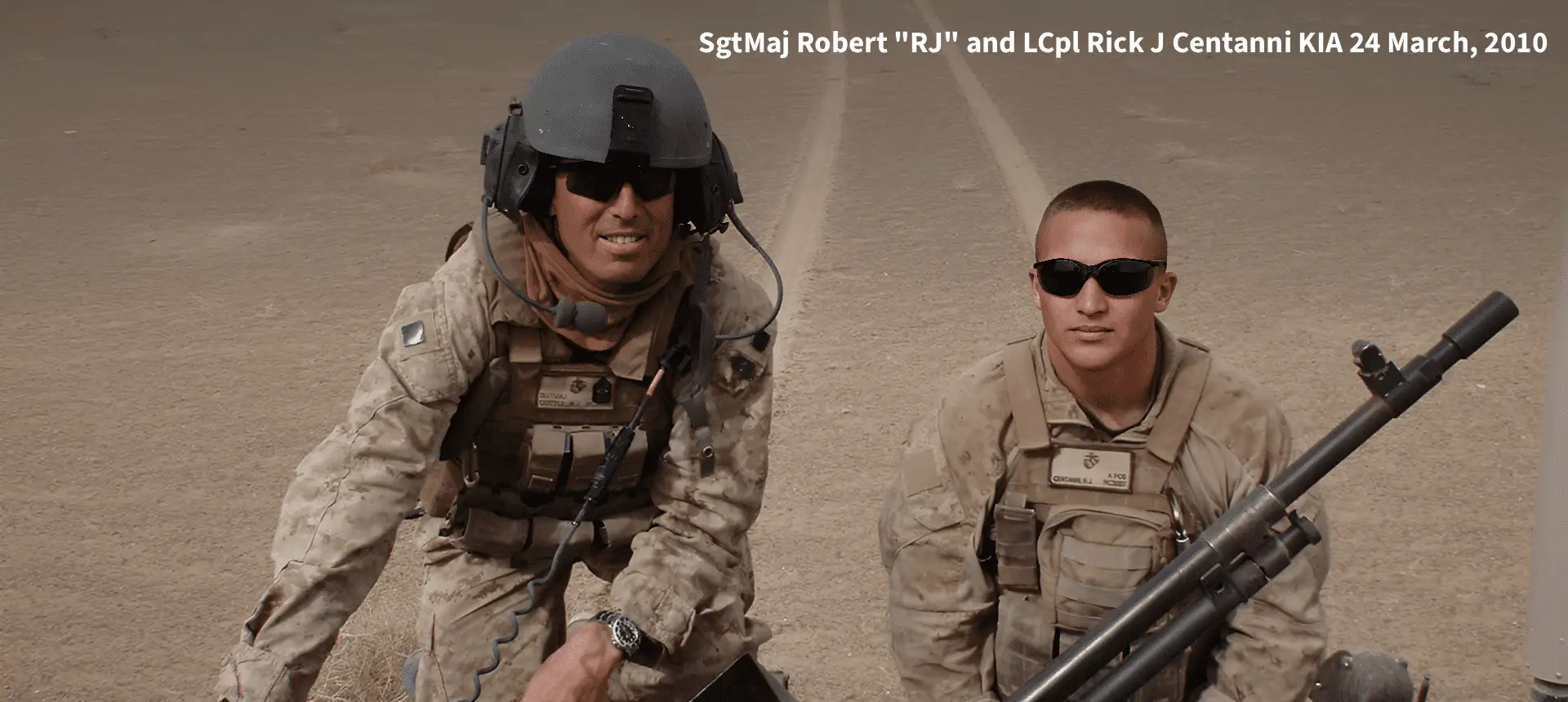 Two soldiers in desert uniforms with weapon