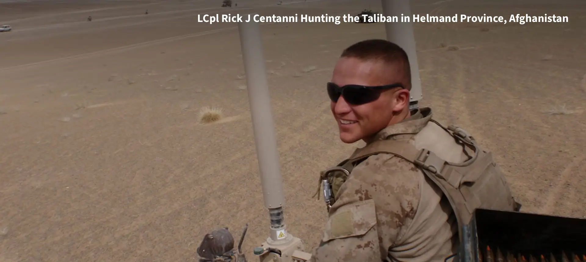 Smiling soldier in desert wearing sunglasses