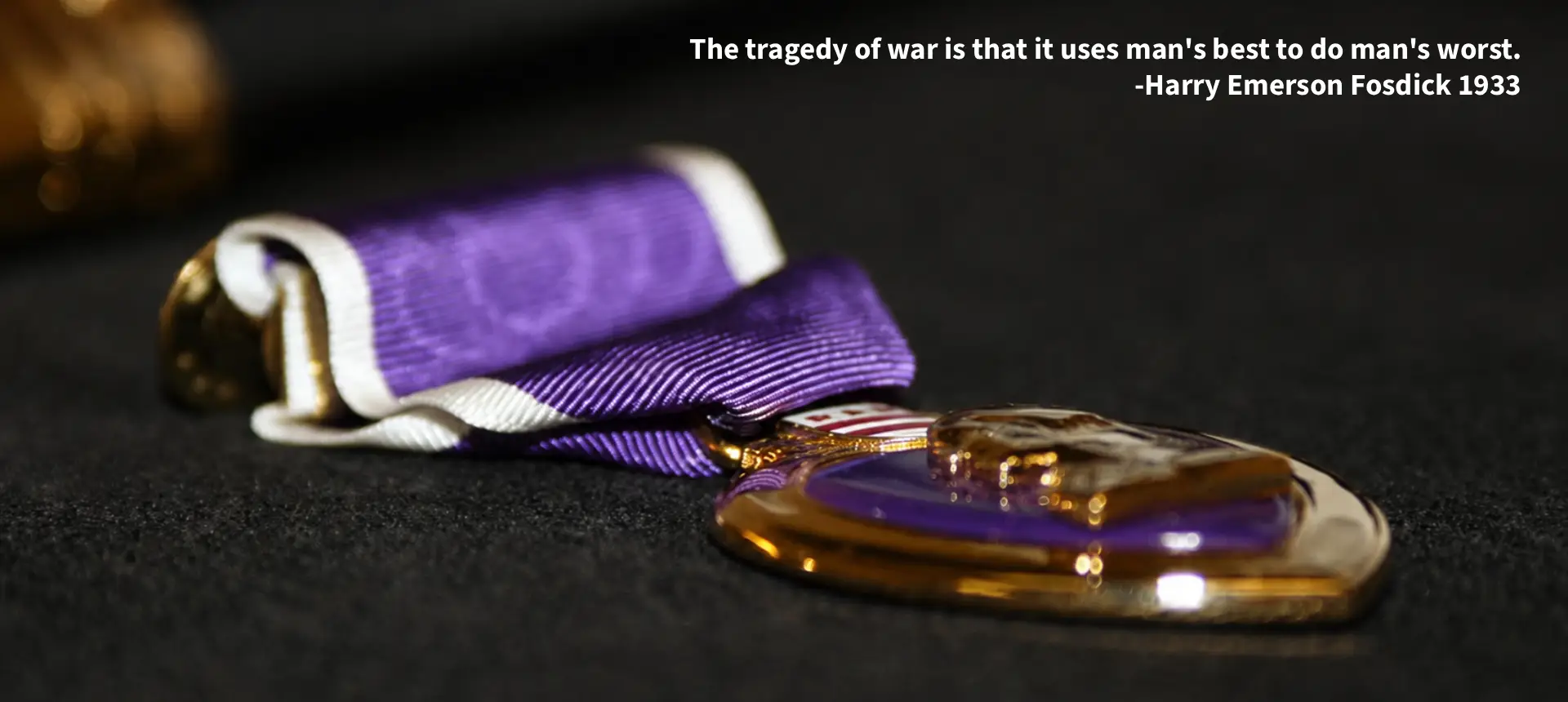 Purple Heart medal with ribbon on black
