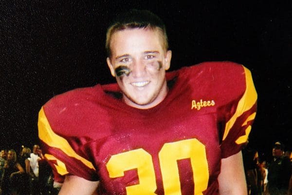 Smiling football player in maroon jersey